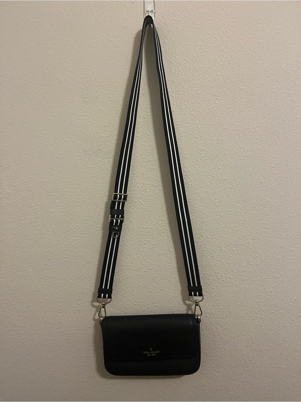 kate spade black crossbody with black-and-white striped strap